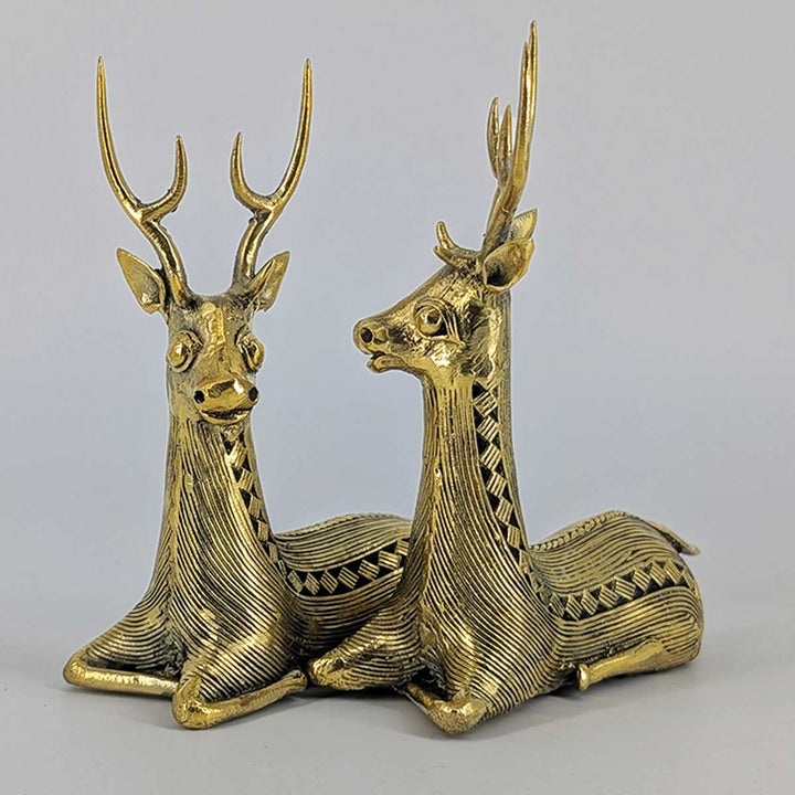 Side view of brass sitting deer figurines showcasing their unique sculptural form.