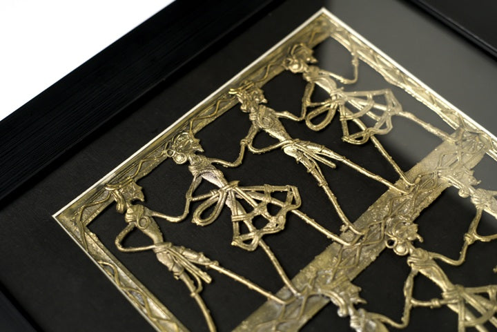 Close-up of intricate Dhokra brass craftsmanship depicting synchronized tribal dancers.