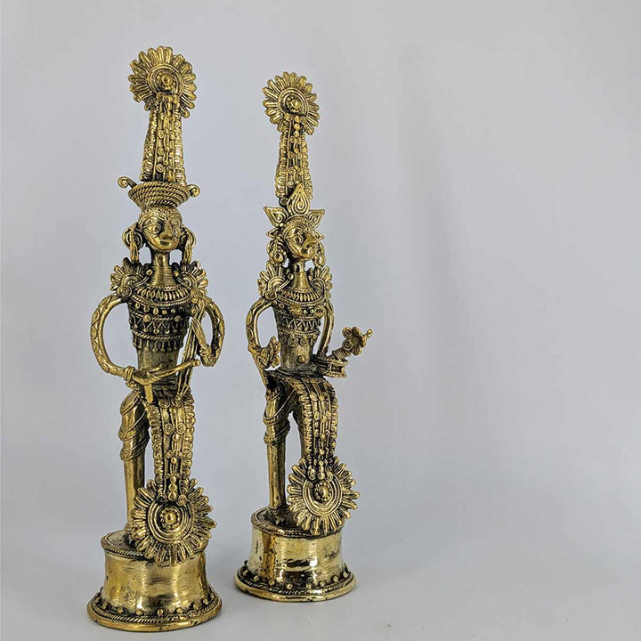 Side view of Jhitku Mitki brass sculpture showcasing ornate headdresses and detailing.