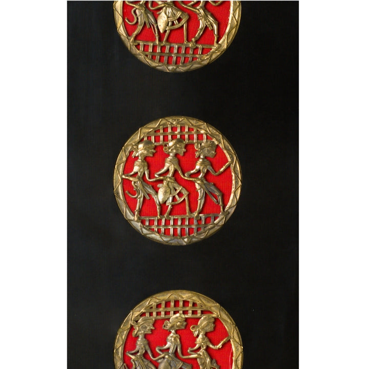 Top-down view of handmade brass dance artwork, emphasizing rich brass detailing and deep black mounting.